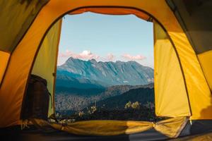 Yellow tent on the mountain and sunset view photo