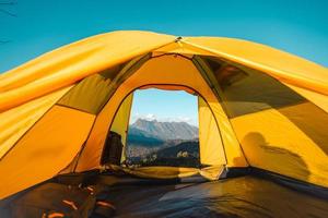 Yellow tent on the mountain and sunset view photo