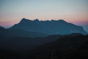 atardecer con vista a la montaña puesta de sol y crepúsculo púrpura foto