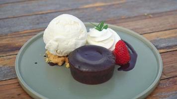 chocolate lava with vanilla ice-cream and whipping cream on plate video