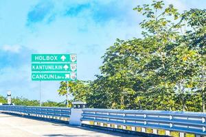 Road sign at highway motorway in jungle tropical nature Mexico. photo