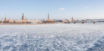 Beautiful winter day in Riga over frozen river covered in ice. White winter in Latvia. photo