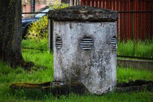 City bomb shelter tower standing in residential yard photo