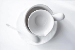 white tea cup, plate and sauser on a table. photo