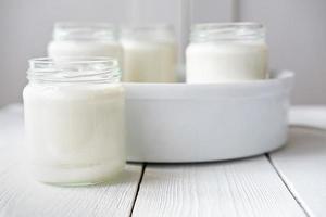 homemade organic yogurt in glass jars in yogurt maker. photo