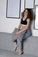 Young woman sitting on the couch. Home portrait. photo