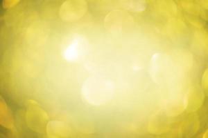 Defocus light yellow sparkles glitter. Abstract background blur focus. photo