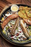 mixed german traditional organic sausage and potato meal platter photo