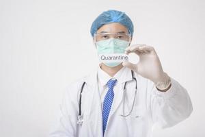 Doctor is holding quanrantine card on white background photo