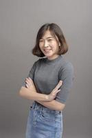 Portrait of young beautiful asian woman over studio background. photo