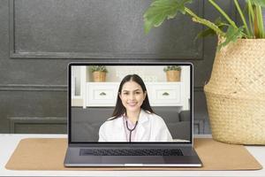 Female doctor making video call on social network with patient consulting about health problems. photo