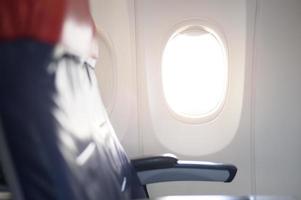 An aircraft cabin with empty passenger rows of seats. photo