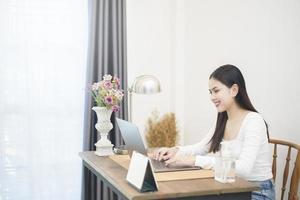 Beautiful woman is working from home photo