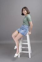 Portrait of young beautiful asian woman over studio background. photo