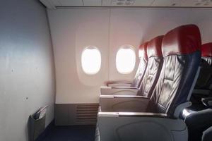 Aircraft cabin with empty passenger rows of seats. photo