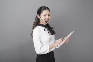 Portrait of beautiful operator woman on gray background photo