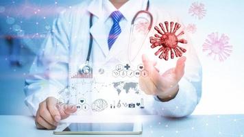 Close up of Doctor is showing digital medical analytics data with 3D of Covid-19 photo
