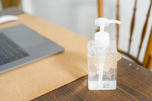 Alcohol gel on working table, healthy concept photo