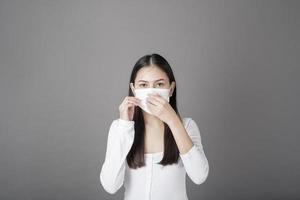 Portrait of woman with surgical mask  in studio, Health care concept photo