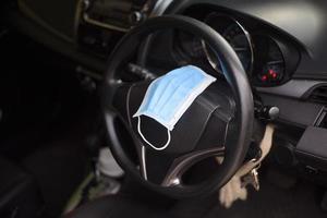 máscara quirúrgica en coche, concepto de protección covid-19 foto