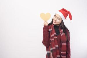 Portrait of young smiling woman wearing red Santa Claus hat isolated white background studio. photo