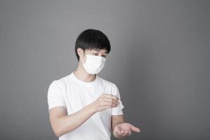 Portrait of Man sanitizing hands with alcohol gel, Health care concept photo