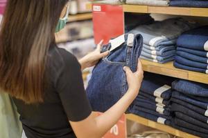 woman with face mask is shopping clothes in Shopping center photo