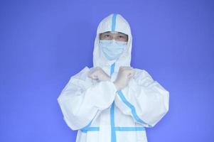 An Asian man is wearing ppe suit on purple background photo