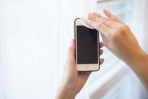 woman is cleaning cell phone photo