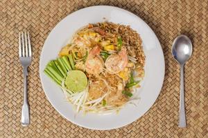 Top view of Thai traditional food  Pad Thai Noodles with shrimp in dish on wooden table photo