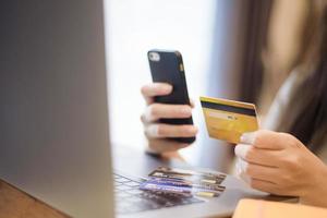 Woman hand is holding credit card, shopping online photo