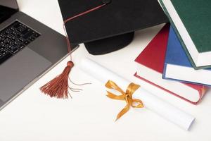 Graduation cap with laptop computer , Online education concept photo