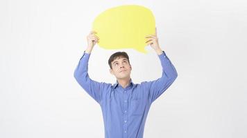 A Caucasian Middle aged Man is holding yellow empty speech on white background photo