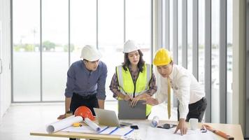 Engineering people are analytics construction plans with blueprint in office photo