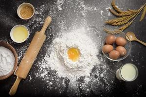 Top view of ingredients bakery making on black wooden table photo