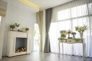 White living room with flowers decorations. photo