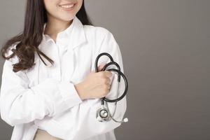 Smart woman doctor is holding stethoscope photo