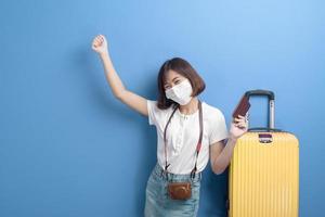 portrait of young traveler woman with face mask , New normal travel concept photo