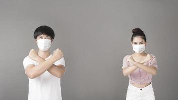 Portrait of man and woman with surgical mask  in studio, social distancing  concept photo