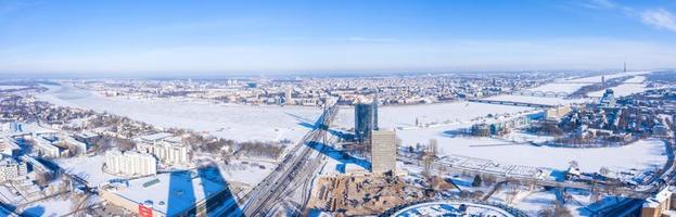 Aerial panoramic view of the Riga city during magical white winter day. Ice old Latvia. photo