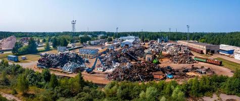 Old damaged cars on the junkyard waiting for recycling photo