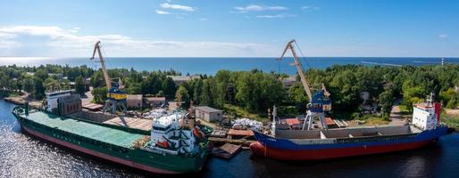 Riga, Latvia. June 10, 2021. Cargo ship at floating dry dock is being renovated photo