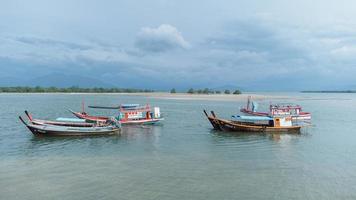 Laem Son National Park, Ranong, Thailand on November 2021 Pier in National park with local fishing boats in Kapur District from aerial view by drone. photo