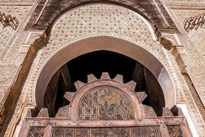 Ancient slamic style carved arch wall of a mosque at fez photo