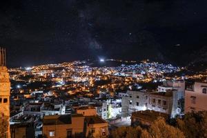 Aerial view of illuminated residential structures in dark at night photo