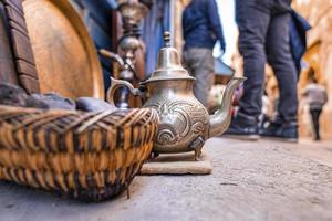 Retro style teapot for sale at street market in Morocco photo