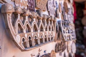 Close up of artifacts or ancient souvenirs for sale at marketplace photo