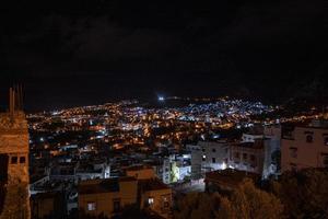 Aerial view of illuminated residential structures in dark at night photo