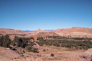 Scenic view of deserted mountain landscape and town with bushes photo