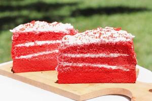 Red velvet cake, classic three layered cake from red butter sponge cakes with cream cheese frosting, American cuisine photo